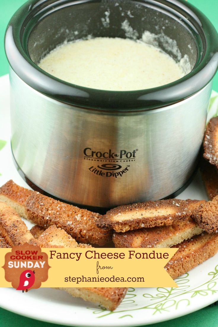 a crock pot and some bread sticks on a plate