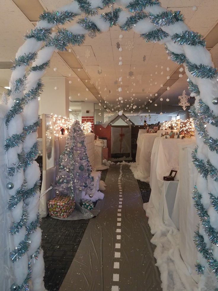 a room filled with lots of white and blue christmas decorations on top of carpeted flooring