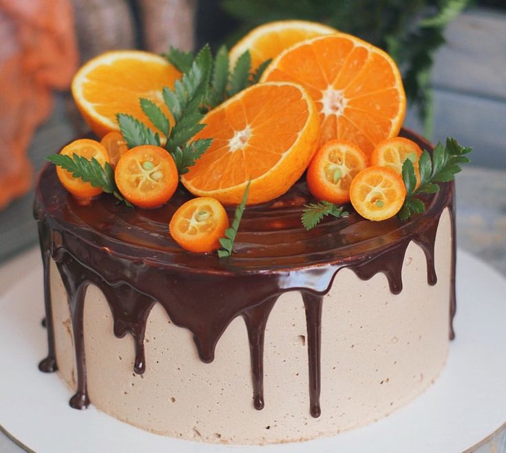 there is a cake with oranges and chocolate icing on the top of it