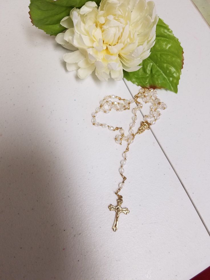 "Beautiful Vintage Rosary, new never been used in original clear box. Makes a perfect gift for Catholic Wedding couple, First Communion, Confirmation, Birthday. Dementions: Decades length: 22\" Complete folded rosary as shown laying on table including crucifix: 16 1/4\" Crucifix: 1 1/4\" x 5/8\" FINAL SALE, NO RETURNS, NO EXCHANGES, PLEASE CONTACT FOR ANY QUESTIONS OR CONCERNS AFTER LOOKING AT ALL THE PICTURES." Gold Rosary With Round Beads As Gift, Gold Round Beads Rosary As Gift, Handmade Cross Rosary For First Communion, Beaded Cross Rosary Bracelet For Gift, Beaded Cross Rosary Bracelet Gift, Gift Beaded Cross Rosary Bracelet, Adjustable Cross Rosary For First Communion, Gold Spiritual Rosary Bracelet For First Communion, Adjustable Cross-shaped Rosary For First Communion