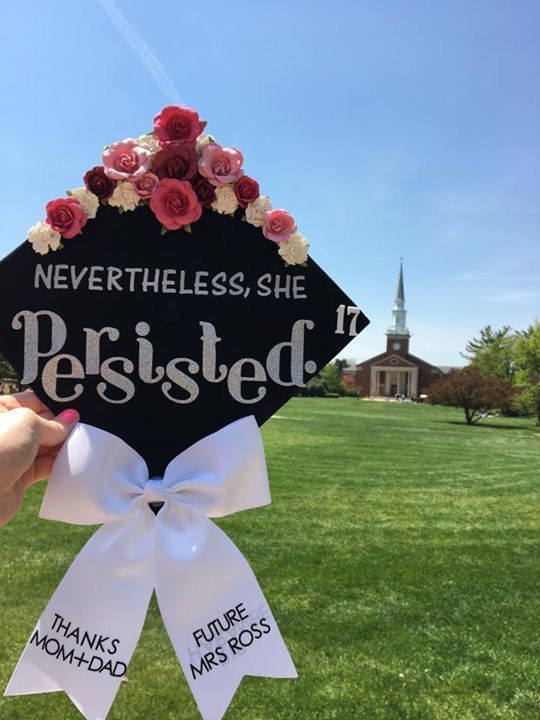 a person holding up a graduation cap with flowers on it that says, neverthless she is perished