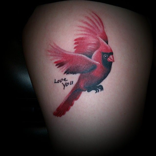 a red bird on the back of a woman's thigh