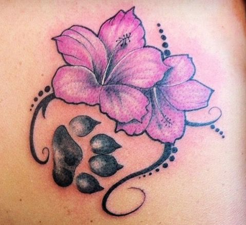 a woman's back with pink flowers on it