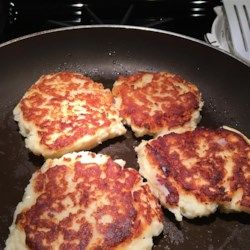 four pancakes cooking in a frying pan on the stove