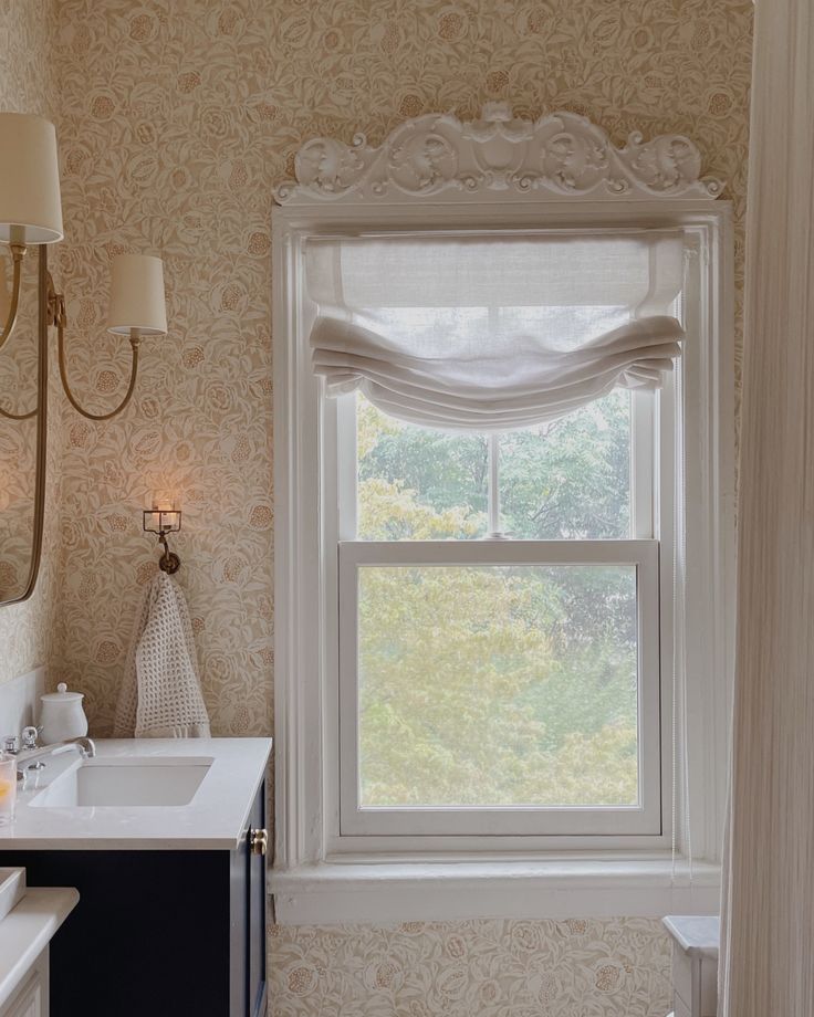 an image of a bathroom with window treatments on the windowsills and in the sink area