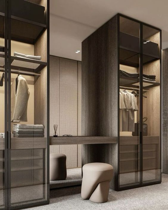 a walk in closet with mirrored doors and drawers