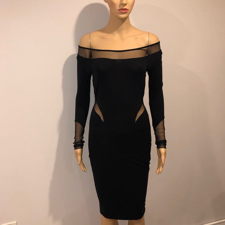 a mannequin wearing a black dress with sheer shoulders