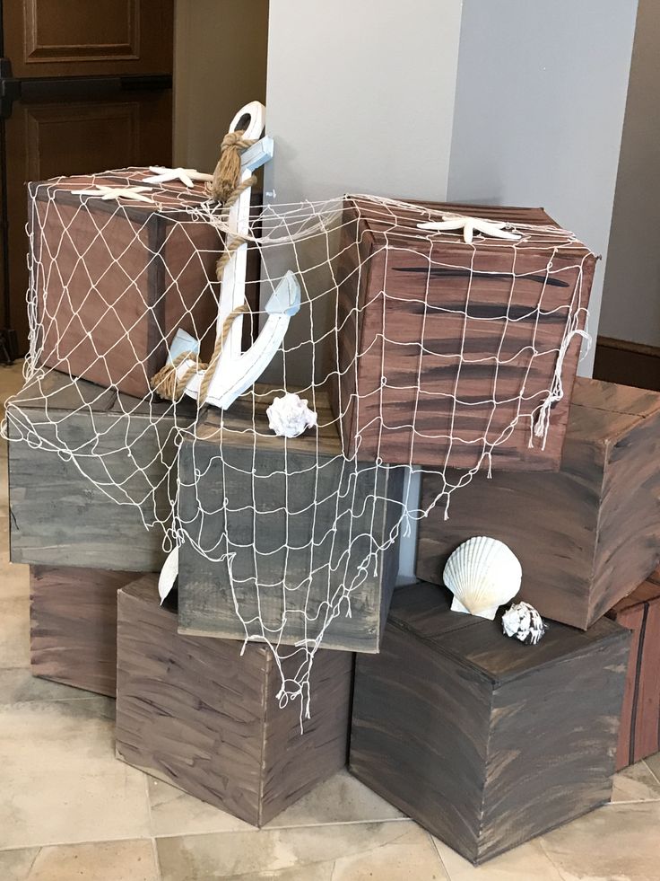 three wooden boxes with rope and seashells on them sitting on top of each other