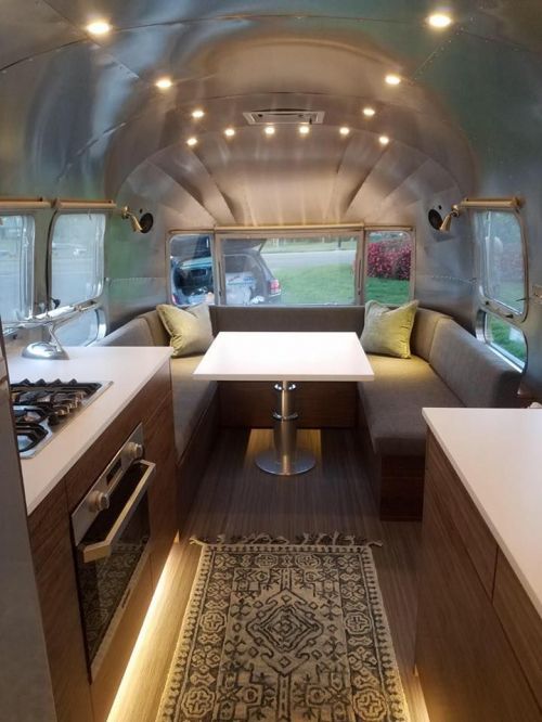 the interior of an airstream is clean and ready to be used as a kitchen