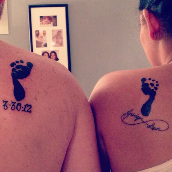 two people with tattoos on their backs that say 2013 and the year they were born