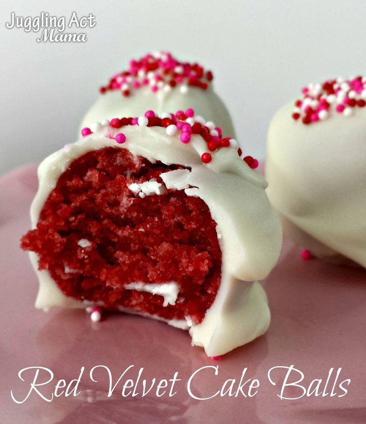 red velvet cake balls with white frosting and sprinkles on a pink plate