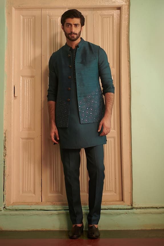 Teal blue silk bundi with sequins hand embroidery. - Aza Fashions Embroidered Chanderi Sherwani For Party, Embellished Fitted Kurta In Raw Silk, Party Traditional Wear With Intricate Embroidery In Cotton Silk, Embellished Fitted Chanderi Kurta, Silk Nehru Jacket With Resham Embroidery For Eid, Silk Nehru Jacket For Eid Reception, Silk Nehru Jacket With Intricate Embroidery For Festive Occasions, Silk Nehru Jacket For Reception During Eid, Fitted Silk Sherwani With Dabka Work