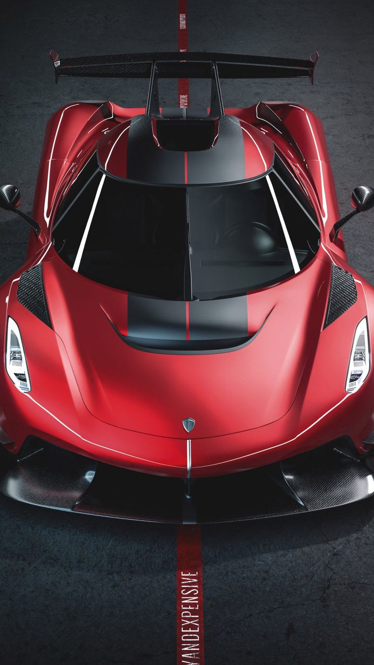 a red and black sports car parked in a parking lot with its hood up on