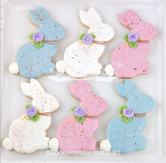 decorated cookies in the shape of bunnies with flowers