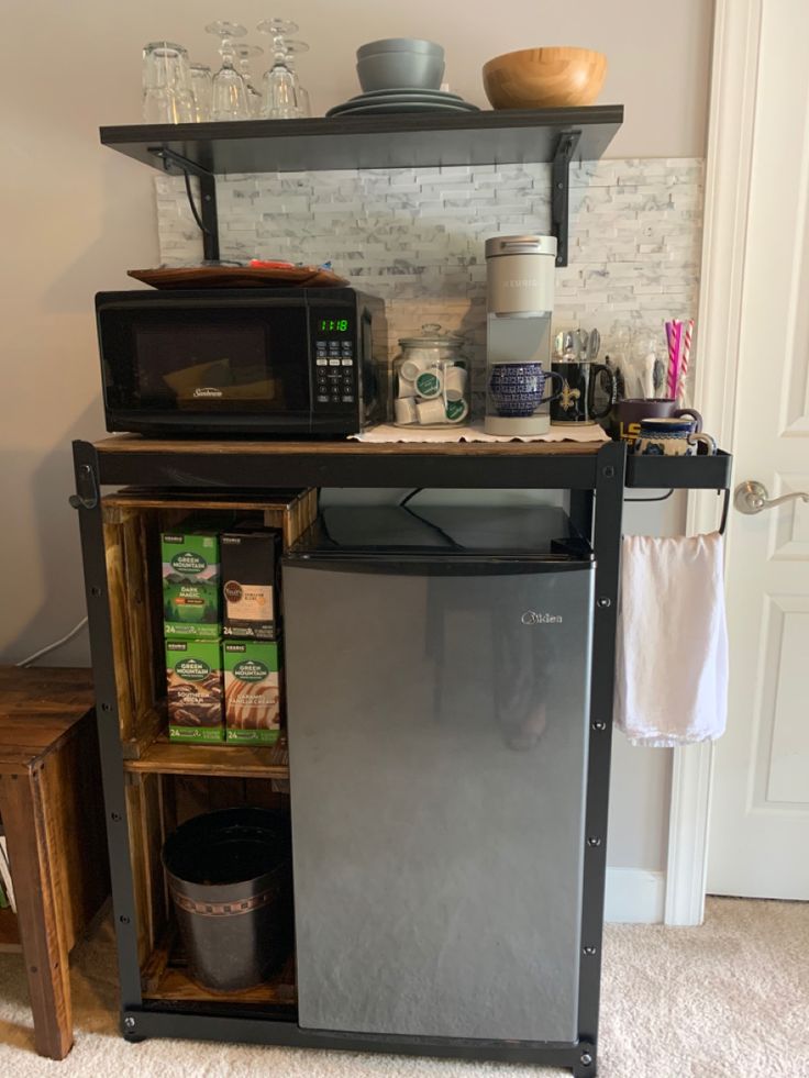 a kitchen with a refrigerator, microwave and other items