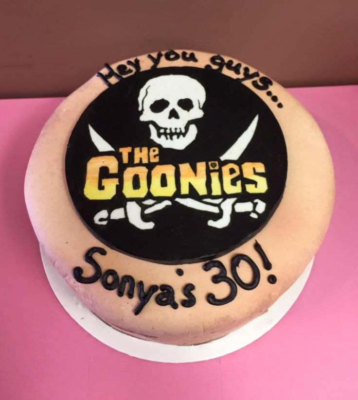 a birthday cake for someone's 30th birthday with a skull and crossbones on it