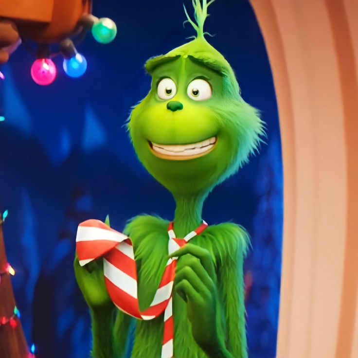 the grinch is holding a candy cane