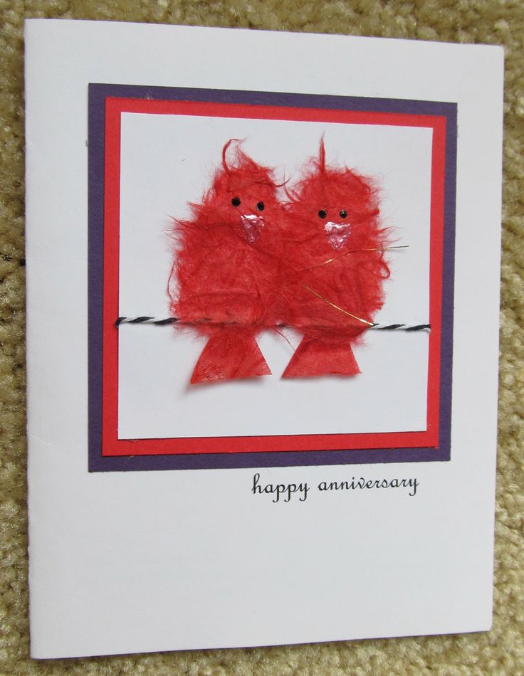 an anniversary card with two red birds on it