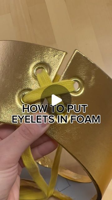 a hand holding a gold object with the words how to put eyelets in foam