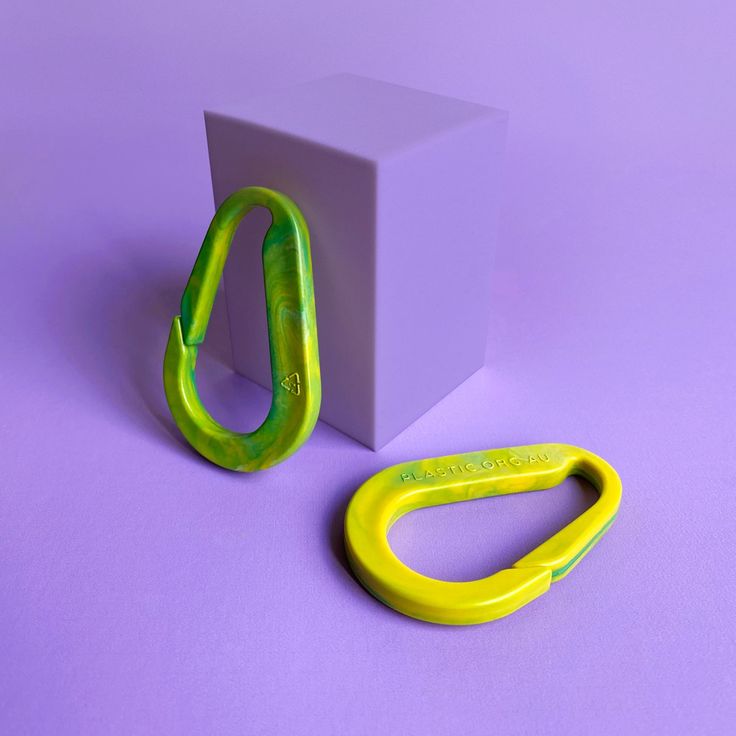 a pair of scissors sitting on top of a purple surface next to a white box