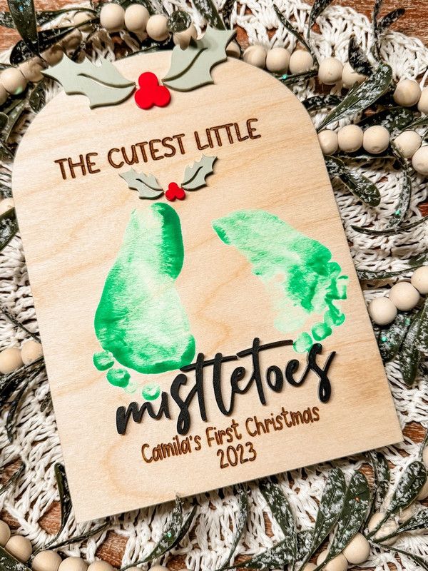 a wooden ornament that says the cute little mistetos on it's side