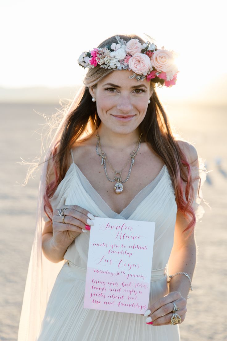 a woman in a wedding dress holding up a sign