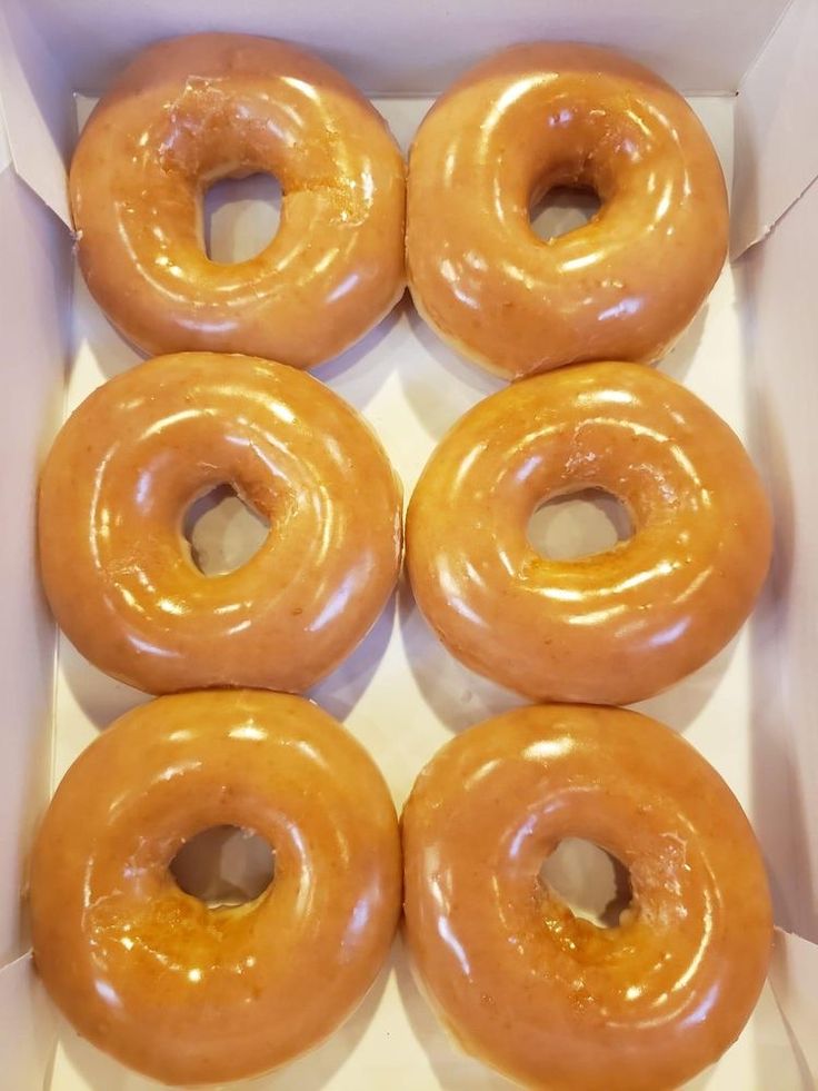 six glazed donuts in a white box