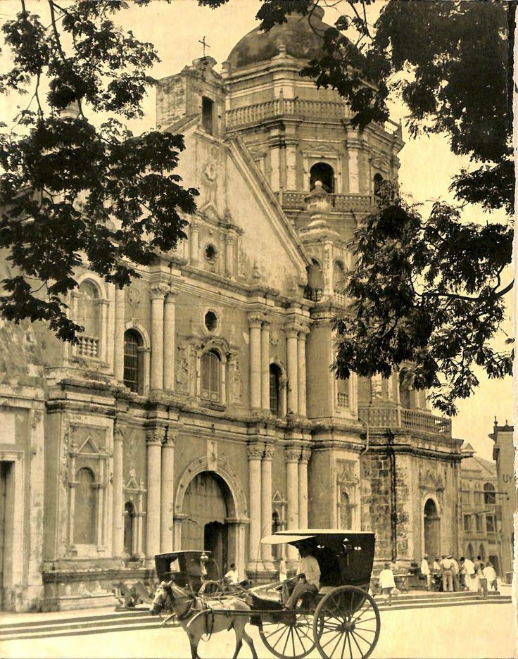 an old photo of a horse drawn carriage in front of a church