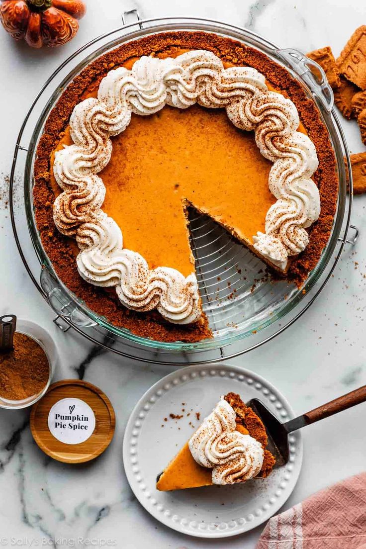 a pumpkin pie with a slice missing from it on a plate next to other desserts