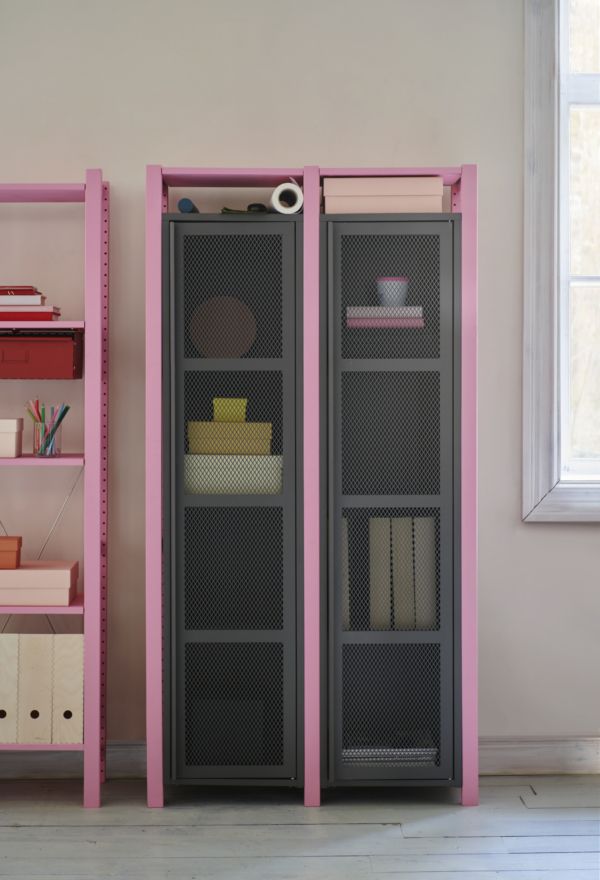 a pink and grey bookcase next to a window