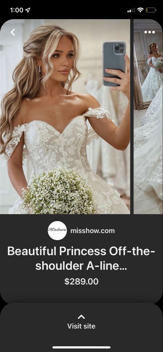 a woman taking a selfie with her cell phone while wearing a wedding dress and holding a bouquet of baby's breath