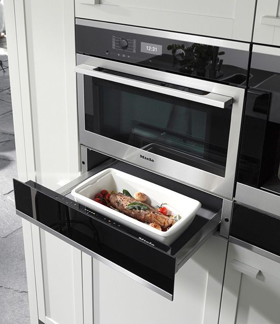 a microwave oven with food in it sitting on the wall next to an oven door