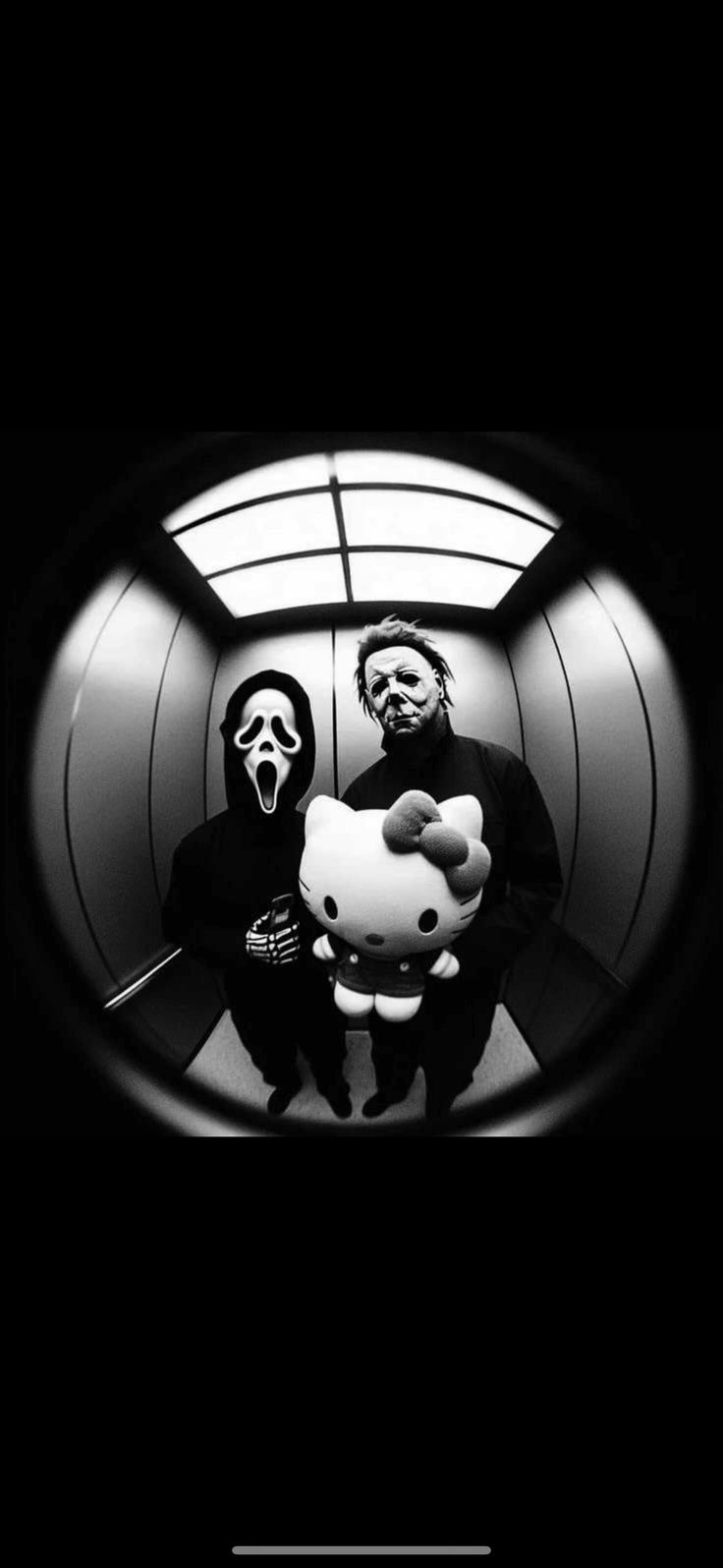 black and white photo of two people with hello kitty