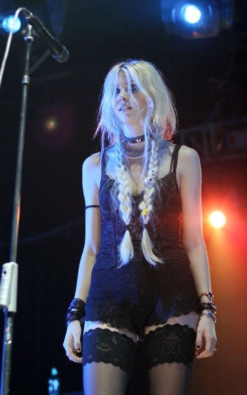 a woman with long hair and braids on stage