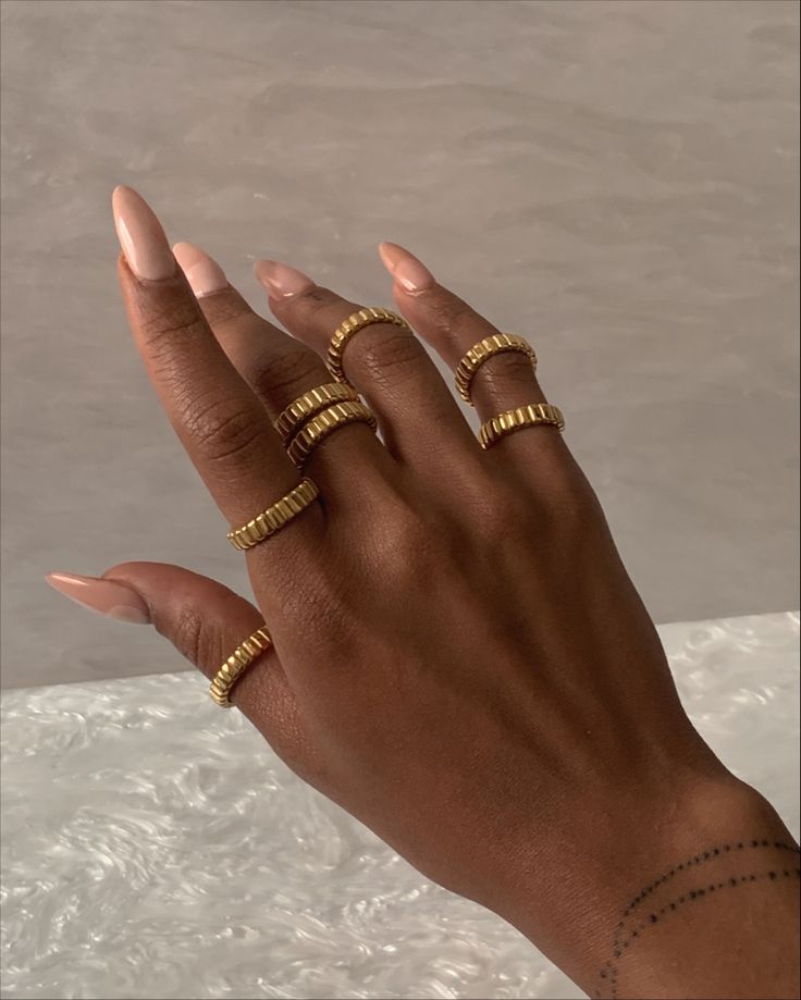 Our Emery ring stacked Gold Stackable Rings For Layering, Trendy Stackable Yellow Gold Jewelry, Gold Minimalist Stackable Rings For Layering, Adjustable 14k Gold Trendy Ring, Adjustable Gold Rings For Layering, Trendy Adjustable 14k Gold Ring, Everyday Yellow Gold Tarnish-resistant Midi Rings, Trendy Tarnish Resistant Yellow Gold Rings, Elegant Gold Stackable Rings For Layering