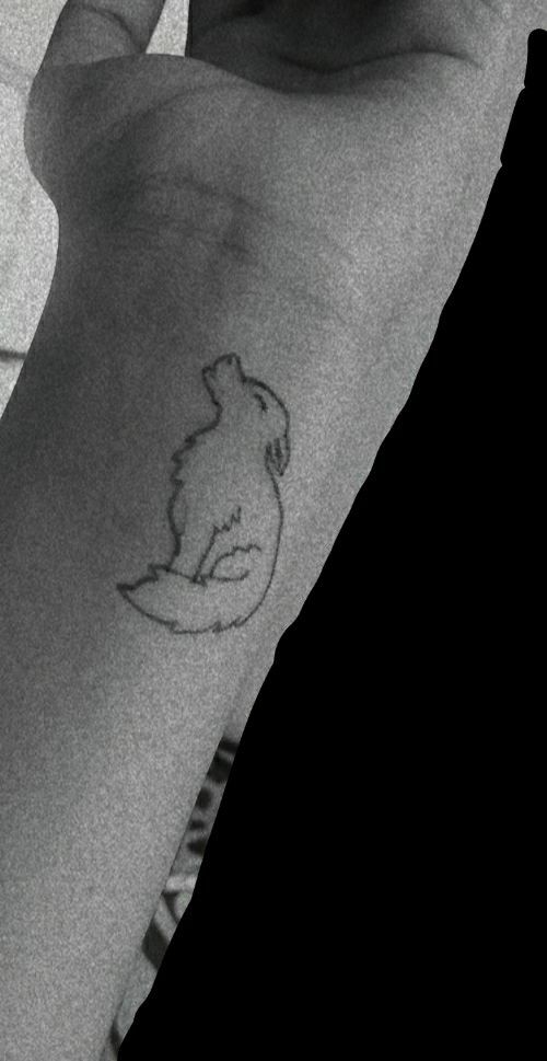 a person's arm with a small tattoo on the left side of their arm