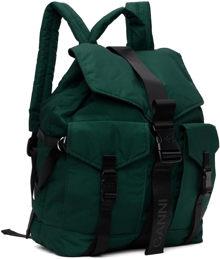 Recycled polyester taffeta backpack in green. · Carry handle · Adjustable padded shoulder straps · Press-release flap pockets · Rubberized logo patch at face · Cinch strap at sides · Logo-bonded press-release flap · Drawstring closure · Zip pocket at interior · Fully lined · Logo-engraved black hardware · H16.5 x W14.5 x D5 Supplier color: Forest night Nylon Backpack With Logo Patch For Streetwear, Green Functional Backpack With Multiple Pockets, Sporty Green Backpack With Adjustable Strap, Functional Green Backpack With Multiple Pockets, Green Nylon Backpack With Pockets, Green Nylon Bag With Multiple Pockets, Functional Green Nylon Backpack, Tech Backpack, Forest Night