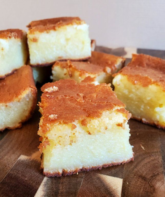 several pieces of cake sitting on top of a wooden cutting board