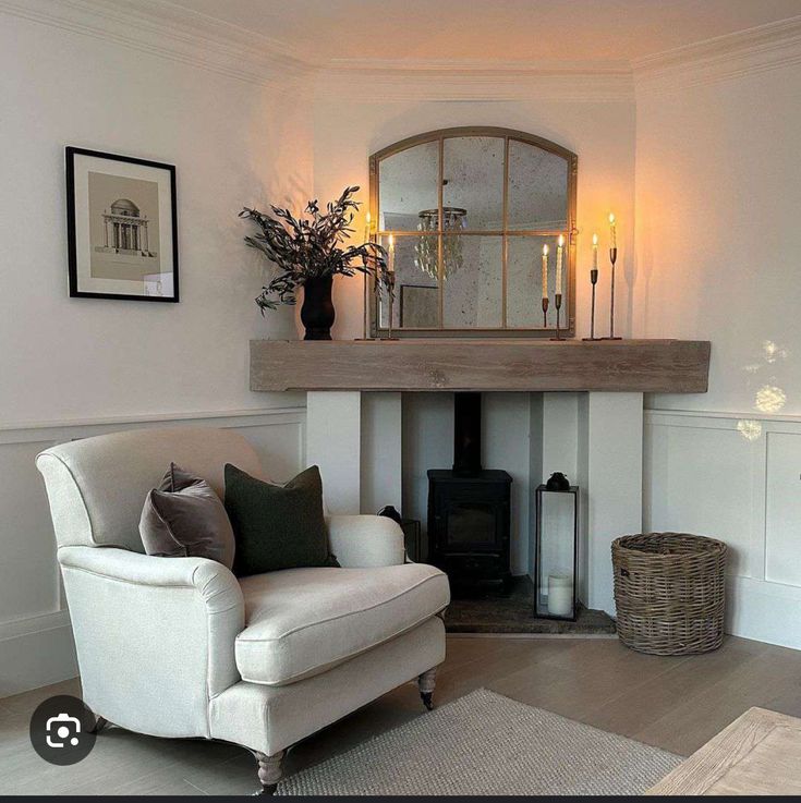 a living room filled with furniture and a fire place next to a wall mounted fireplace