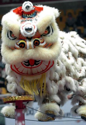 a white and red lion costume on display