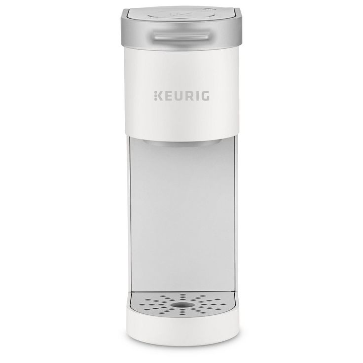 the keurig single serve coffee maker is white and has a silver trimming