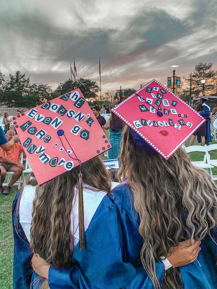 two girls in graduation caps and gowns are hugging each other at the commencement ceremony