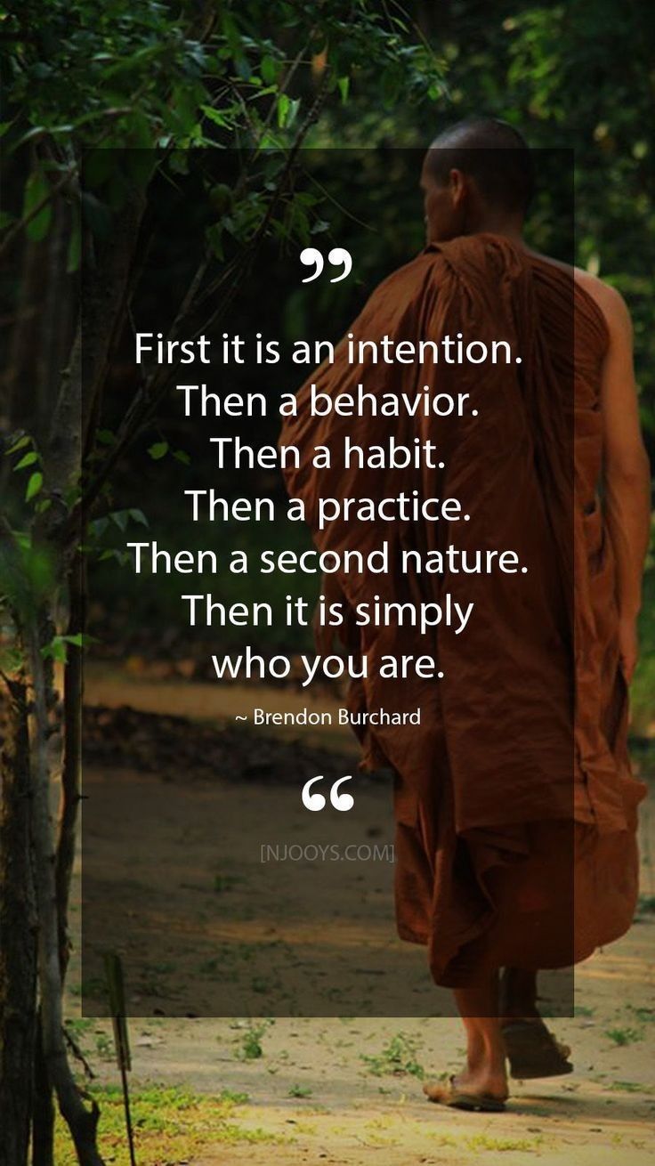 a monk standing in front of a tree with a quote on it that says first it is an intention then a behavior then a habit