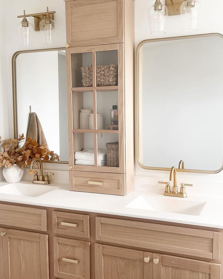 a bathroom with two sinks and a large mirror