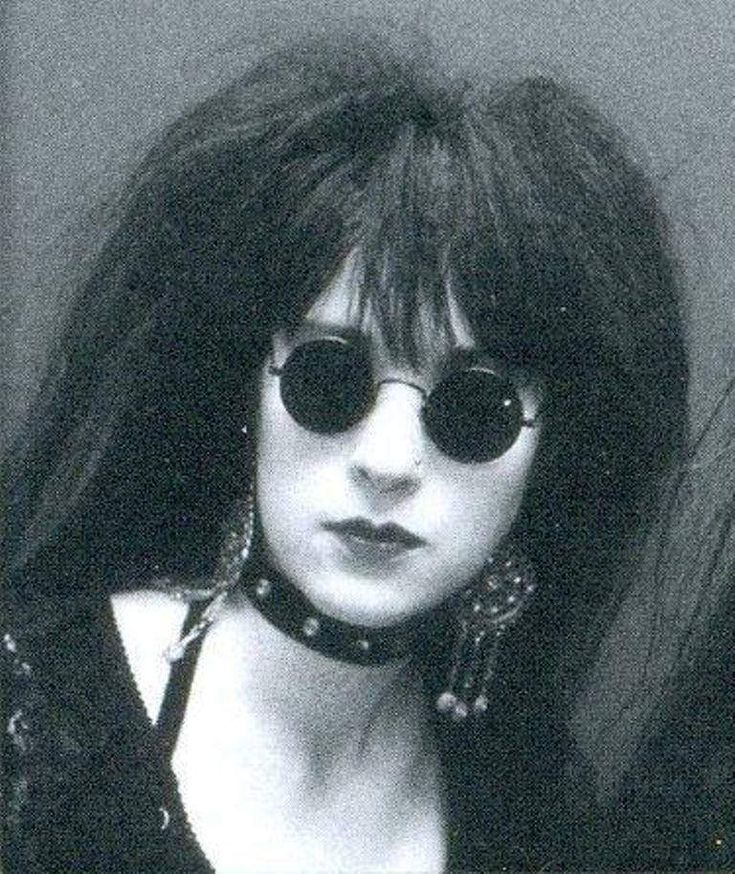 a black and white photo of a woman wearing sunglasses