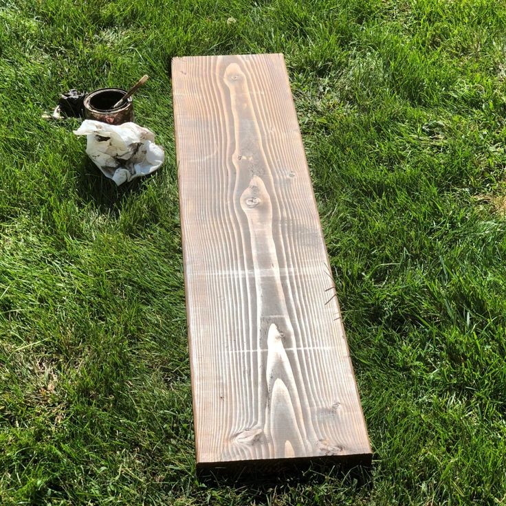 a piece of wood laying on top of green grass