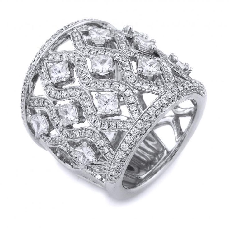 a white gold ring with diamonds on the sides and an intricate design in the middle