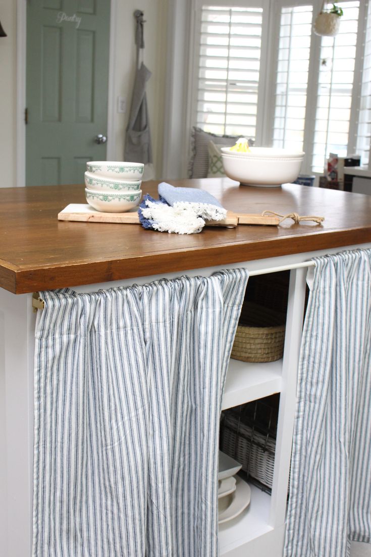 a kitchen island with a wooden counter top