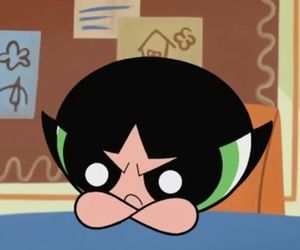 the face of an animated character with green eyes and black hair, in front of cardboard boxes