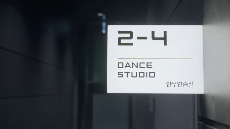 a sign hanging from the side of a building that says 2 - 4 dance studio